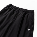 ナイロンスパン4ウェイジップパンツ - ブラック