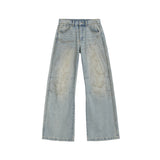 curved-cut mud-dyed jeans