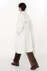 Waist-cinched, straight-cut, with a plaid patchwork design and raglan sleeves, this trench coat features a bold silhouette.