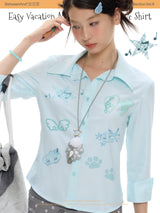 BETWEENAND summer shirt with mint blue stripes, diamond-encrusted waistline, and short sleeves