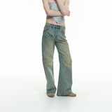 curved-cut mud-dyed jeans