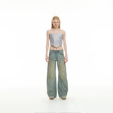 curved-cut mud-dyed jeans