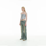 curved-cut mud-dyed jeans
