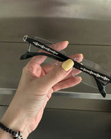 chrome cross-rimmed glasses