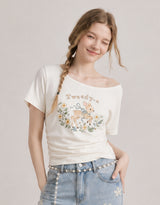 ダイアサマーヴィンテージグラフィックシャーリングワンショルダーTシャツ アイボリー