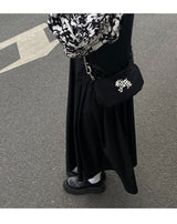 Betweenand "The original Dalmatian underarm satchel is a small black bag that people can't put down"
