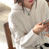 サッドツイストボタンセミジップアップフーディー長袖ニット