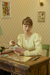 バックリボンニット