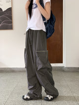 アコンジッパーポケットナイロンワイドツーウェイジョガーパンツ/ Acorn Zip Pocket Nylon Wide Two Way Joggers